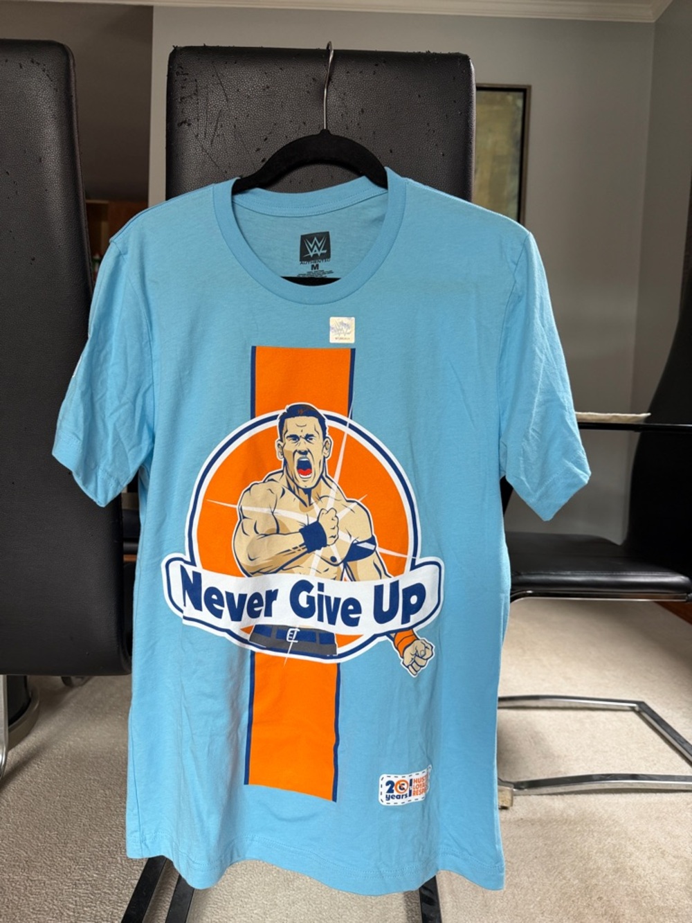 WWE Light Blue 'Never Give Up' Tee with Orange Graphic. John cena.